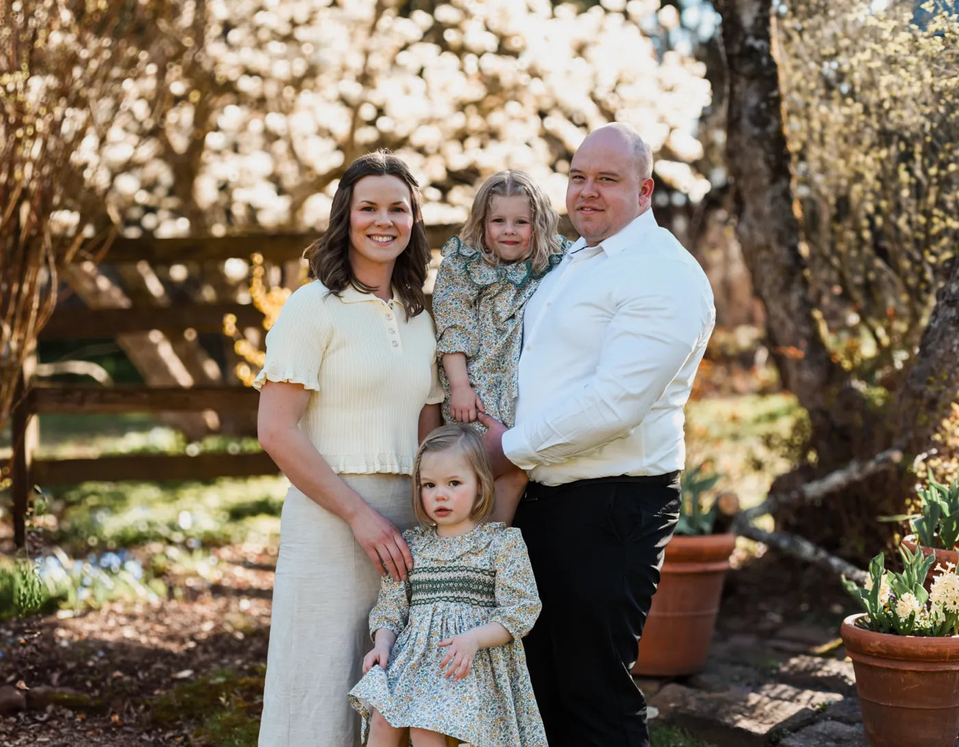 The River Haze Ragdolls family - husband, wife and their two young daughters - outdoors in spring
